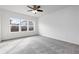 Neutral bedroom featuring plush carpet, and a large window offering natural light at 6284 N Genoa Way, Aurora, CO 80019