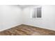 Bedroom featuring wood look floors and a window providing natural light at 6284 N Genoa Way, Aurora, CO 80019