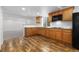 Kitchen offering wood look floors, wood cabinets and dark appliances at 6284 N Genoa Way, Aurora, CO 80019