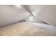 Finished attic with neutral carpet and a dormer window at 1304 Ceres Dr, Lafayette, CO 80026