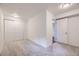 Bright bedroom featuring neutral carpet, white walls, closet with sliding doors, and updated fixtures at 1304 Ceres Dr, Lafayette, CO 80026