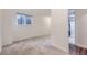 Bright room with a window, a doorway view of the shower, neutral carpet and white walls at 1304 Ceres Dr, Lafayette, CO 80026