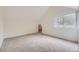Bright bedroom features neutral carpet, an archway to another room, and a window at 1304 Ceres Dr, Lafayette, CO 80026