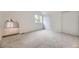 Bedroom with neutral carpet features a window and an archway at 1304 Ceres Dr, Lafayette, CO 80026