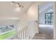 Bright staircase landing features white banisters and a view of the backyard at 1304 Ceres Dr, Lafayette, CO 80026