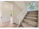 Bright staircase features neutral carpet, white banister, and a large window letting in natural light at 1304 Ceres Dr, Lafayette, CO 80026