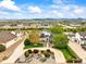 Expansive aerial view of a home with manicured lawns, mature trees, and mountain views in the distance at 2161 Elmwood St, Berthoud, CO 80513