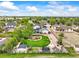 Aerial view showcasing the expansive backyard with play area, a well-maintained lawn, and surrounding neighborhood at 2161 Elmwood St, Berthoud, CO 80513