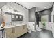 Modern bathroom with a double vanity, striking backsplash, and a separate shower/tub area at 2161 Elmwood St, Berthoud, CO 80513