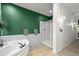 Elegant bathroom with a corner soaking tub, glass shower, and modern fixtures for a spa-like experience at 2161 Elmwood St, Berthoud, CO 80513