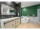 Inviting bathroom featuring a soaking tub, double vanities, and modern fixtures for a luxurious experience at 2161 Elmwood St, Berthoud, CO 80513