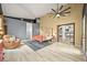Bright bedroom with a cozy sitting area, large windows, and views into the spacious kitchen at 2161 Elmwood St, Berthoud, CO 80513