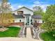 Charming two-story home with a manicured lawn, landscaped garden, and inviting walkway leading to a teal front door at 2161 Elmwood St, Berthoud, CO 80513
