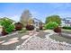 Beautifully landscaped front yard featuring decorative gravel, flagstone accents, and mature trees at 2161 Elmwood St, Berthoud, CO 80513