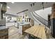 Modern kitchen with a wooden island, pendant lighting, white cabinets, and dining table at 2161 Elmwood St, Berthoud, CO 80513