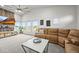 Bright living room featuring large windows, modern furnishings, and a comfortable seating arrangement for relaxation at 2161 Elmwood St, Berthoud, CO 80513