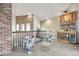 Upstairs living area featuring brick accents, a bar area, and stylish seating, great for entertaining guests at 2161 Elmwood St, Berthoud, CO 80513