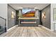 Modern living room featuring an electric fireplace, stylish decor, and hardwood flooring at 2161 Elmwood St, Berthoud, CO 80513
