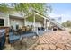 Outdoor patio featuring a dining set, hot tub, and steps leading to the second-story deck at 2161 Elmwood St, Berthoud, CO 80513