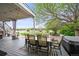 Covered patio including outdoor dining area, a hot tub, a grill, and outdoor furniture at 2161 Elmwood St, Berthoud, CO 80513