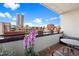 Relaxing balcony with potted flowers, seating, and views of the city skyline at 1475 Delgany St # 306, Denver, CO 80202