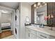 Stylish bathroom with stackable washer/dryer, modern vanity, and elegant mirror with lighting at 1475 Delgany St # 306, Denver, CO 80202