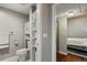Bathroom featuring modern fixtures, shelving, and access to bedroom at 1475 Delgany St # 306, Denver, CO 80202