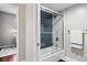 Well-lit bathroom with shower/tub combination, modern fixtures, and access to bedroom at 1475 Delgany St # 306, Denver, CO 80202