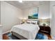 Bright bedroom featuring a comfortable queen-sized bed, stylish artwork, and modern lamps at 1475 Delgany St # 306, Denver, CO 80202