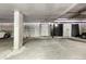 Spacious garage with concrete floors and storage units, providing ample space for vehicles and storage at 1475 Delgany St # 306, Denver, CO 80202