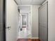 Hallway with laundry area, storage closet and views of bedroom and bathroom at 1475 Delgany St # 306, Denver, CO 80202