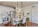 Charming kitchen with white cabinets, stainless steel appliances, and dining table in an open floor plan at 1475 Delgany St # 306, Denver, CO 80202