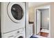 Laundry area with stackable washer/dryer, adjacent to bathroom and hallway at 1475 Delgany St # 306, Denver, CO 80202