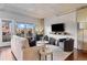 A bright living room with modern furnishings, hardwood floors, and a balcony with city views at 1475 Delgany St # 306, Denver, CO 80202