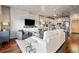 Stylish living room open to kitchen featuring concrete ceilings, hardwood floors and modern decor at 1475 Delgany St # 306, Denver, CO 80202