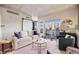Bright living room with a barn door, hardwood floors, a comfortable sofa and a balcony with city views at 1475 Delgany St # 306, Denver, CO 80202