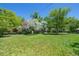Expansive backyard with lush green grass, mature trees, and privacy at 5265 W Quarles Dr, Littleton, CO 80128