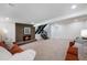 Spacious basement featuring brick fireplace with hearth, staircase, and comfortable seating area at 5265 W Quarles Dr, Littleton, CO 80128