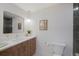 A modern bathroom with white countertop, wood cabinets, and a decorative mirror at 5265 W Quarles Dr, Littleton, CO 80128