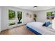 A bedroom with bright natural light, with large windows, and wood flooring at 5265 W Quarles Dr, Littleton, CO 80128