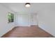 A well-lit empty bedroom with a closet and view of the exterior through a large window at 5265 W Quarles Dr, Littleton, CO 80128