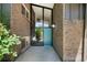 Inviting entryway with large glass panels and a stylish blue front door, enhanced by brick accents at 5265 W Quarles Dr, Littleton, CO 80128