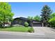 Charming single-Gathering home with an attached garage, lush front lawn and mature shade trees in a serene setting at 5265 W Quarles Dr, Littleton, CO 80128