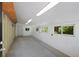 Spacious garage featuring ample storage, natural light, and an additional door at 5265 W Quarles Dr, Littleton, CO 80128