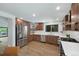 This kitchen features stainless steel appliances, white countertops, and stylish wood cabinets at 5265 W Quarles Dr, Littleton, CO 80128