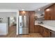 A bright modern kitchen featuring stainless steel appliances, white countertops, and stylish wood cabinets at 5265 W Quarles Dr, Littleton, CO 80128