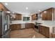 A bright modern kitchen featuring stainless steel appliances, white countertops, and stylish wood cabinets at 5265 W Quarles Dr, Littleton, CO 80128
