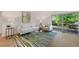 Bright living room with sliding doors leading to a deck, modern furniture, and stylish decor at 5265 W Quarles Dr, Littleton, CO 80128