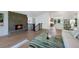 Cozy living room with a brick fireplace, hardwood floors, and an open layout at 5265 W Quarles Dr, Littleton, CO 80128