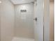 Modern shower featuring white tiling, built in niche, and contemporary shower head at 5265 W Quarles Dr, Littleton, CO 80128